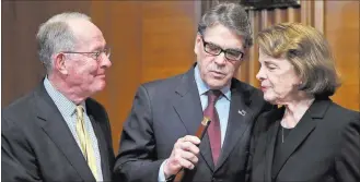  ?? Alex Brandon ?? Chairman Lamar Alexander, R-tenn., left, Energy Secretary Rick Perry, and Sen. Dianne Feinstein, D-calif., look at a cane that once belonged to Sam Houston that is now owned by Alexander, before Perry testified Wednesday during a hearing of the Senate...