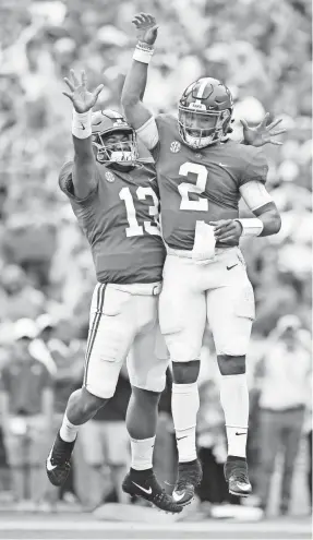  ?? JOHN DAVID MERCER/USA TODAY SPORTS ?? Alabama quarterbac­k Jalen Hurts (2) celebrates a touchdown against Tennessee with Tua Tagovailoa in 2017.