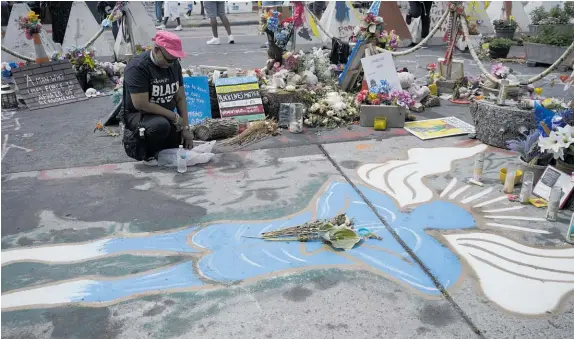  ?? Photos / AP ?? The spot where George Floyd was killed has become a memorial to what happened.