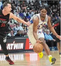  ?? — AP ?? Going through: philadelph­ia 76ers guard tyrese Maxey (right) dribbles the ball during the match against Miami Heat in an NBA game on thursday.