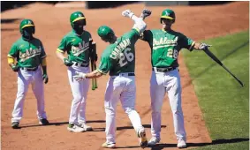  ?? BEN MARGOT/ASSOCIATED PRESS ?? Oakland’s Matt Chapman (26) celebrates with Matt Olson after hitting a home run in the Athletics’ victory over Houston on Saturday. It was the A’s eighth straight win.