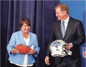  ?? AP ?? Titans owner Amy Adams Strunk and NFL Commission­er Roger Goodell prepare for a photo after it was announced Wednesday that Nashville will host the 2019 NFL draft.