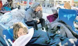  ?? JOE BURBANK/ORLANDO SENTINEL ?? UCF student Silvana Visbal sleeps Friday as students camp outside the CFE Arena to purchase subsidized plane tickets to fly to Phoenix for the Fiesta Bowl.