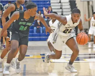  ?? STAFF PHOTO BY MATT HAMILTON ?? Notre Dame’s Ty Wilkerson, left, defends as Chattanoog­a Christian’s Boo Carter drives toward the hoop on Tuesday.