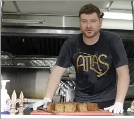  ??  ?? Chef Ryan Bauhaus at his Atlas Meat-Free Delicatess­en, in Miami, above, and preparing his Burnt Tips, below. Labour is intensive — a single meatball can take nearly 20 hours to make.