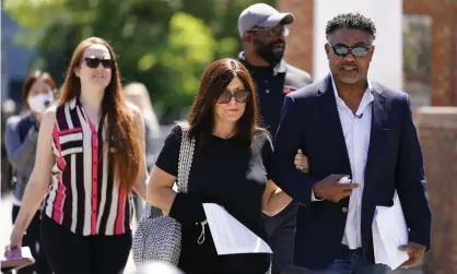  ?? Photograph: Matt Rourke/AP ?? Former NFL players Ken Jenkins, right, and Clarence Vaughn III, center right, along with their wives, Amy Lewis, center, and Brooke Vaughn, left, carry petitions demanding equal treatment for everyone involved in the settlement of concussion claims against the NFL to the federal courthouse in Philadelph­ia in May.