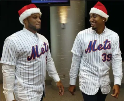  ?? RICHARD DREW - THE ASSOCIATED PRESS ?? Robinson Cano, left, and Edwin Diaz wear Santa hats as they arrive to participat­e in New York Mets annual Kids Holiday Party, at CitiField, in New York, Tuesday, Dec. 4, 2018. The Mets acquired eight-time All-Star second baseman Robinson Cano and major league saves leader Edwin Diaz from the Seattle Mariners in a seven-player trade Monday.