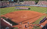  ?? Sue Ogrocki / Associated Press ?? A large flag is unfurled in the outfield before the second game of the best-of-three championsh­ip series between Florida and Oklahoma in the NCAA Women’s College World Series in Oklahoma City, in 2017.