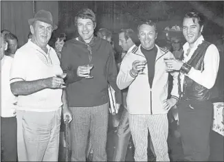  ?? Steve Binder Archives ?? A CELEBRATOR­Y moment backstage for Presley’s TV special: Col. Parker, left, producer-director Steve Binder, executive producer Bob Finkel and Presley hoist a glass of the bubbly.