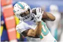  ?? ADRIAN KRAUS/AP ?? Miami Dolphins running back Malcolm Perry makes a catch in the second half of a game against the Buffalo Bills on Jan. 3. Perry was claimed by the New England Patriots on Wednesday after being waived by the Dolphins on Tuesday.