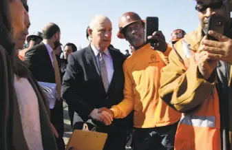  ?? Lea Suzuki / The Chronicle ?? Willie Robertson (center), a Local 324 laborer, takes a selfie with Gov. Jerry Brown as Brown arrives in Concord to speak at a news conference about his plan to raise vehicle license fees.