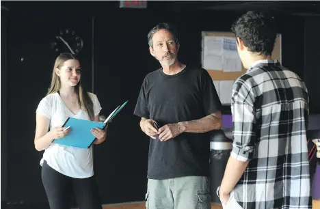  ?? NICK PROCAYLO ?? Director Mike Stack is flanked by actors Maggie Stewart and Finnegan Howes during a rehearsal for the Shakespear­e play Romeo and Juliet.
“I had some callbacks and I looked at some different young people for Romeo and Juliet, and there was an ease with...