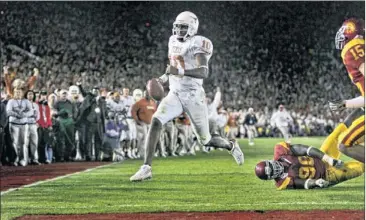  ??  ?? Vince Young’s end zone scamper capped off the 2006 BCS National Championsh­ip Game and sealed the game’s place on our list of the best games we’ve ever watched.