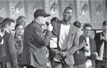  ?? — AFP file photo ?? Feige (left) welcomes Ali on stage during the Marvel panel in Hall H of the Convention Centre during Comic Con in San Diego, California July 20.