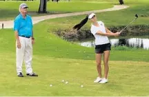  ??  ?? Instructor Bobby Impaglia watches as his star pupil, 16-year-old Dana Williams of Boca Raton, works on her pitch shots.