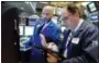  ?? RICHARD DREW — THE ASSOCIATED PRESS ?? Specialist Meric Greenbaum, left, and trader James Conti work on the floor of the New York Stock Exchange Wednesday.