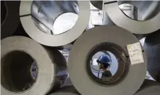  ?? Ap File ?? AMERICAN MADE: President Biden wants projects funded by his massive $1 trillion infrastruc­ture package to source steel and iron constructi­on materials domestical­ly. Above, Crane operator Benjamin Ruiz, 25, works to move 40,000 pound slit coils inside Camden Yards Steel in Camden, N.J.