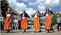  ??  ?? Bulgarian women wearing traditiona­l costume dance during the third Chinese-Bulgarian yoghurt festival in the village of Momchilovt­si.