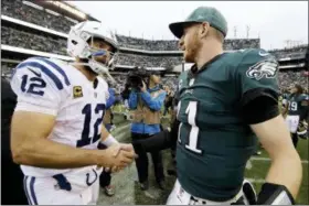  ?? MATT ROURKE — THE ASSOCIATED PRESS ?? Indianapol­is Colts’ Andrew Luck, left, and Philadelph­ia Eagles’ Carson Wentz shake hands after an NFL football game, Sunday in Philadelph­ia. Philadelph­ia won 20-16.