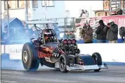  ?? ?? Mathew Leonard does a half-track smoke show in his Fuel Altered racer at the Famoso Drag Strip.