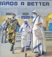  ??  ?? A CISF jawan helps a nun cast her vote in Kolkata on Thursday.