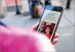  ?? — reuters ?? A person uses a cellphone to read a news article on the announceme­nt by Catherine that she is undergoing preventati­ve chemothera­py in New York City on March 22.