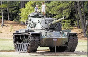  ?? Arkansas Democrat-Gazette/THOMAS METTHE ?? Like children for years before them, Colin Moore, 5, and his sister Brynn, 7, play on the M60 main battle tank at Burns Park in North Little Rock on Friday.