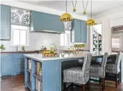  ??  ?? Kitchen cabinetry is painted blue.