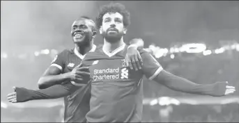  ??  ?? Liverpool’s Mohamed Salah celebrates scoring their first goal with Sadio Mane REUTERS/Andrew Yates.