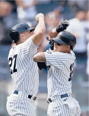  ??  ?? The Yankees’ Rougned Odor, right, celebrates hitting a home run with Giancarlo Stanton during the sixth inning against the Seattle Mariners on Saturday in New York.