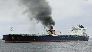  ?? /Reuters ?? Fire onboard: Smoke rises from Marlin Luanda, a merchant vessel, after the vessel was struck by a Houthi antiship missile in the Gulf of Aden on Friday.