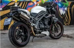  ??  ?? clockwise from below Single-sided swingarm is a thing of beauty; digital instrument­s offer advanced functional­ity and are clear; arrow pipes look and sound the part; hooliganis­m comes standard with the Speed Triple RS.