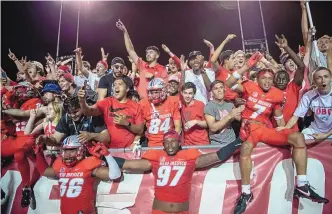  ?? ROBERTO E. ROSALES/JOURNAL ?? UNM players celebrate with enthusiast­ic fans after Saturday night’s 34-25 victory over New Mexico State at University Stadium. The Lobos are on a four-game win streak, their best streak since 2016.