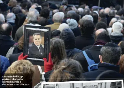  ?? PHOTOS: GETTY IMAGES ?? A woman holds up portrait of Alberto Nisman during a demonstrat­ion this year