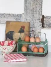  ??  ?? An antique egg stand in the kitchen sits alongside a Thirties oil painting of a hen.