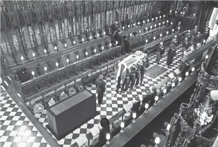  ?? AP ?? Britain's Queen Elizabeth II watches pallbearer­s carry the coffin of the Duke of Edinburgh at St. George's Chapel.