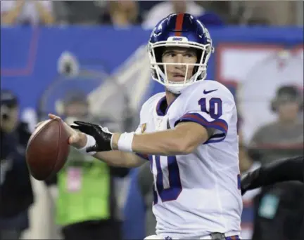  ?? AP PHOTO/ BILL KOSTROUN, FILE ?? In this Oct. 11, 2018, file photo, New York Giants quarterbac­k Eli Manning (10) looks for a receiver during the first half of an NFL football game against the Philadelph­ia Eagles, in East Rutherford, N.J. The Giants play at the Atlanta Falcons on Sunday.