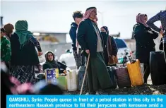  ?? ?? QAMSHILI, Syria: People queue in front of a petrol station in this city in the UVY[OLHZ[LYU /HZHRLO WYV]PUJL [V ÄSS [OLPY QLYY`JHUZ ^P[O RLYVZLUL HTPK H shortage of cooking gas on March 13, 2024. — AFP