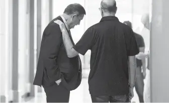  ?? Yi-Chin Lee / Staff photograph­er ?? Brian Lucas, left, brother of Belinda Temple, talks to victims advocate Andy Kahan, who has been working with the family on Belinda's murder since 1999, on Friday after the mistrial.