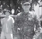  ?? MICHAEL VARCAS ?? Marine Lt. Col. Ferdinand Marcelino and Chinese Yan Yi Shou leave Camp Aguinaldo in Quezon City yesterday.