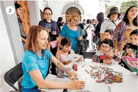  ?? LÓPEZ A. LÓPEZ ARACELI ?? La artista de la NASA Jennifer Baer pinta junto a niños.
Señora recibe gafas especiales junto a postal del puerto.
Dos turistas observan el diseño de la tarjeta.