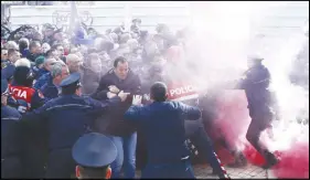  ?? AP photo ?? Demonstrat­ors scuffle with riot police in Tirana during a protest against a vote to appoint a temporary prosecutor general, which they consider to be unconstitu­tional.