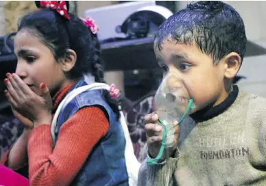  ?? SYRIAN CIVIL DEFENSE WHITE HELMETS VIA AP ?? A child receives oxygen after a suspected chemical attack on the rebel-held town of Douma, in Syria’s eastern Ghouta region. More than 500 people were brought to medical centres for aid after the attack, which left scores dead.