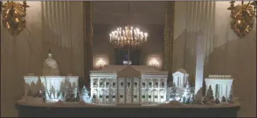  ?? The Associated Press ?? WHITE HOUSE CHRISTMAS: The gingerbrea­d house, showcasing the full expanse of the National Mall: the Capitol, the Lincoln Memorial, the Jefferson Memorial, the Washington Monument, and, the White House is seen in the State Dining Room during the 2018 Christmas Press Preview at the White House in Washington, Monday. Christmas has arrived at the White House for 2018 as first lady Melania Trump unveiled the holiday decor. She designed the decor, which features a theme of “American Treasures.”