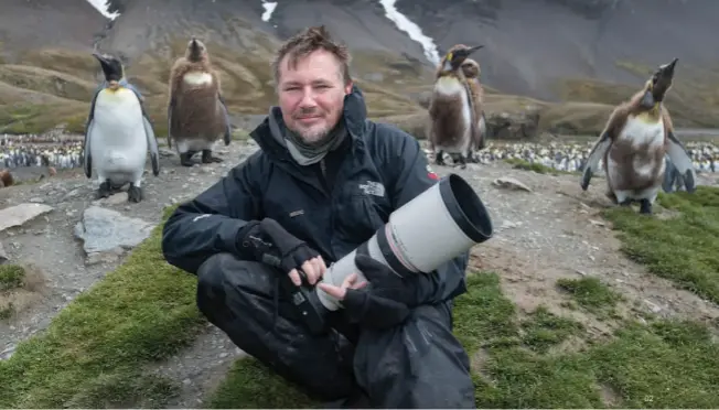  ??  ?? 02 The author, Dale R Morris, chilling with penguins on South Georgia Island in the Antarctic zone 03 A gelada is a rare monkey that lives exclusivel­y in the Ethiopian highlands. There are many photo tours available that specialise in unusual species and far-flung destinatio­ns. 02