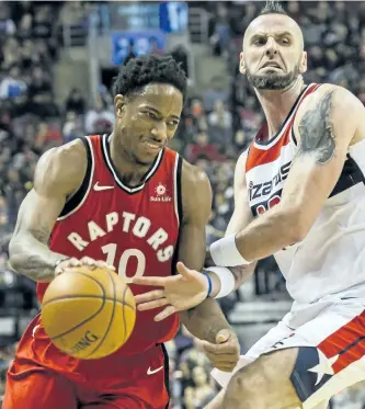  ?? CHRISTOPHE­R KATSAROV/ THE CANADIAN PRESS ?? Toronto Raptors’ guard DeMar DeRozan dribbles past Washington Wizards centre Marcin Gortat in first half NBA basketball action against the Washington Wizards, in Toronto, on Sunday.