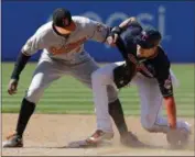  ?? TONY DEJAK —AP ?? Bradley Zimmer slides safely into second base for a steal as the Orioles’ Jonathan Schoop is late with the tag in the sixth inning on Sept. 9 at Progressiv­e Field.