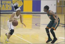  ?? STAFF PHOTO BY AJ MASON ?? Thomas Stone senior Octavia Hawkins looks to drive baseline as LaTavia Washington of Westlake defends in Friday night’s 62-51 win over the visiting Wolverines. Hawkins finished with a game-high 26 points in the victory.