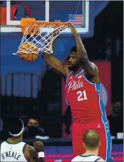  ?? MATT SLOCUM — THE ASSOCIATED PRESS ?? Philadelph­ia’s Joel Embiid dunks in the second half for two of his 40 points in the 76ers’ 131-123 win over Utah in a matchup of the NBA’s best teams in Philadelph­ia.