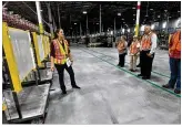  ?? NICK GRAHAM / STAFF ?? Amazon Fulfillmen­t Center general manager Jane Tschanen leads a tour of the facility in August in Monroe. The facility is expected to be operating by early 2019.